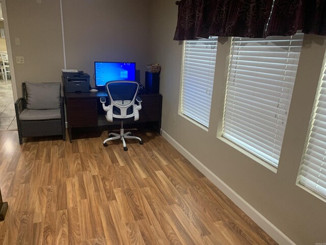 home office with wood finished floors and baseboards