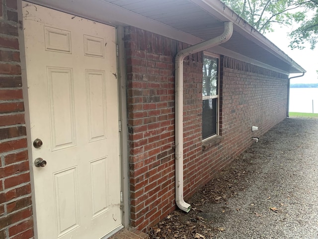 view of exterior entry with brick siding