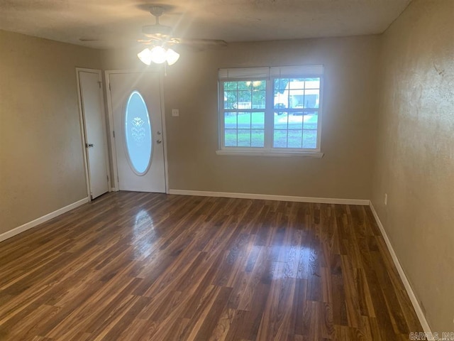 entryway featuring a ceiling fan, baseboards, and wood finished floors