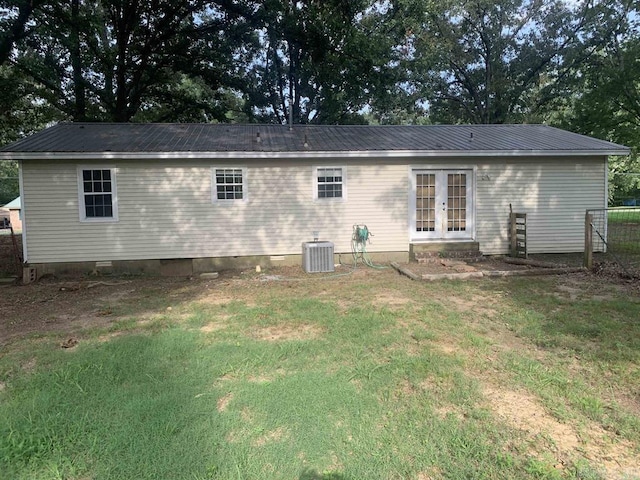 rear view of house with crawl space, cooling unit, french doors, and metal roof