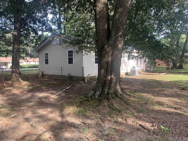 view of side of home featuring central AC