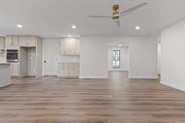 unfurnished living room featuring recessed lighting, light wood-type flooring, baseboards, and ceiling fan