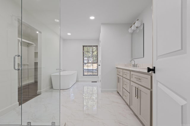 full bath featuring a freestanding tub, marble finish floor, a shower stall, baseboards, and vanity