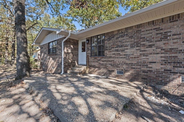 exterior space with brick siding and crawl space