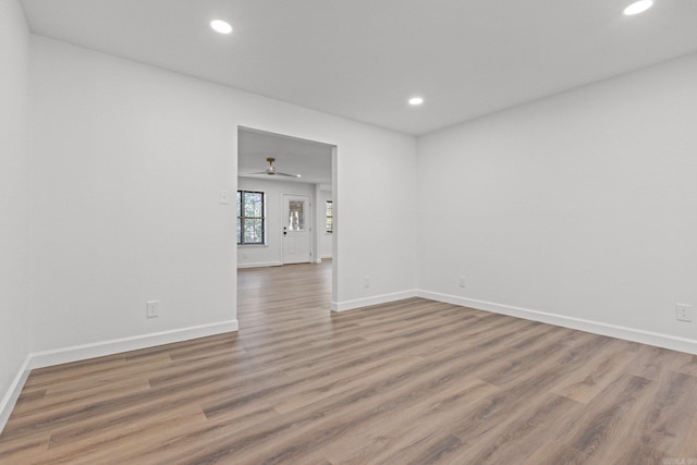 spare room with recessed lighting, baseboards, wood finished floors, and a ceiling fan