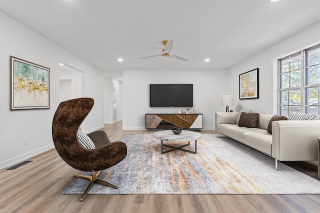 living area with visible vents, recessed lighting, baseboards, and wood finished floors