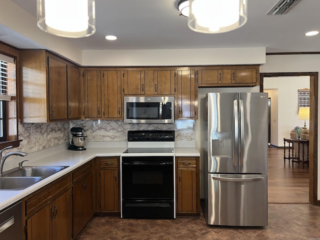 kitchen with decorative backsplash, stainless steel appliances, light countertops, and a sink