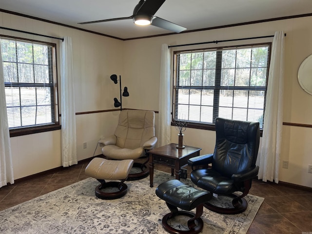 sitting room featuring crown molding, a ceiling fan, baseboards, and tile patterned floors