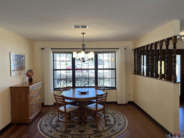 dining area featuring a notable chandelier, baseboards, visible vents, and dark wood-style flooring