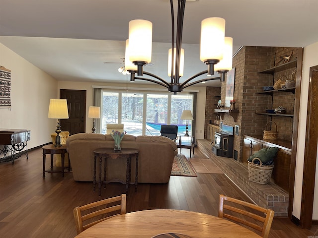 dining area with baseboards, an inviting chandelier, and dark wood-style floors