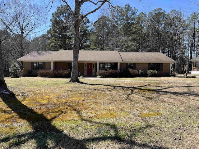 ranch-style home with brick siding and a front lawn