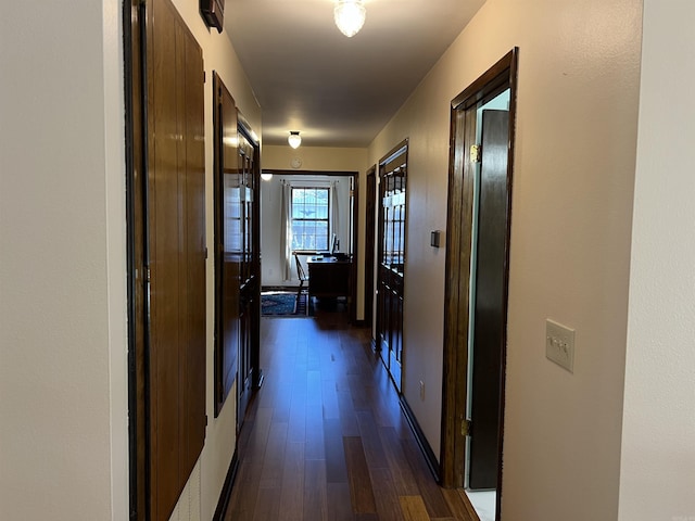 corridor featuring dark wood-style floors