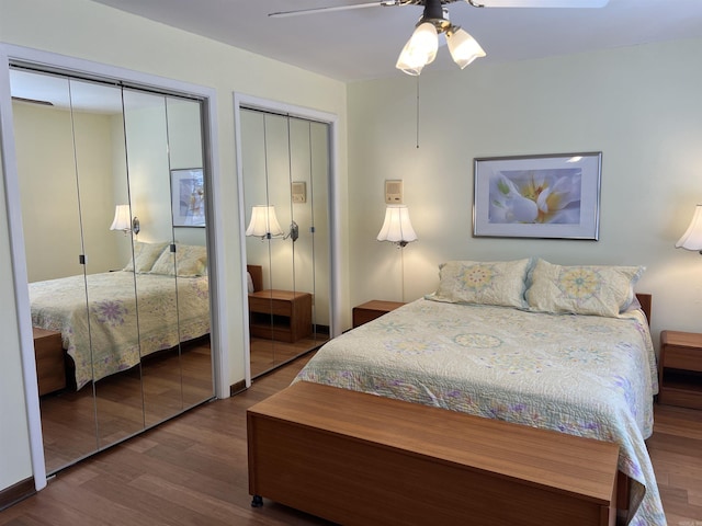 bedroom with multiple closets, wood finished floors, and a ceiling fan