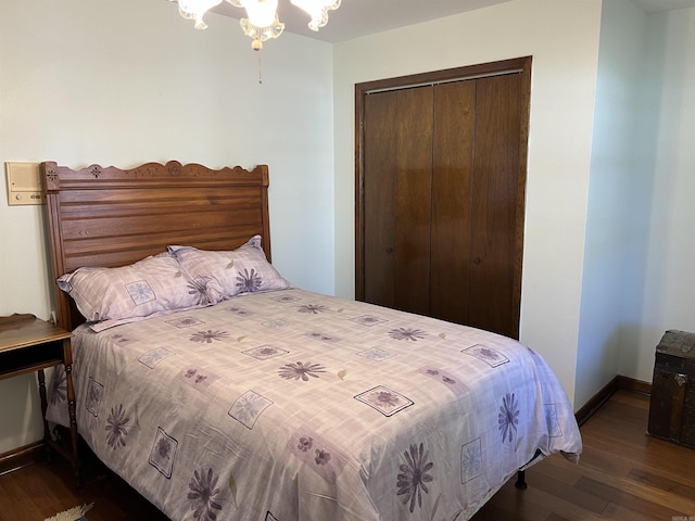 bedroom featuring a closet, baseboards, and wood finished floors