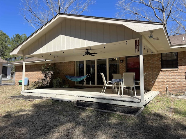 rear view of property featuring brick siding, ceiling fan, and a patio area