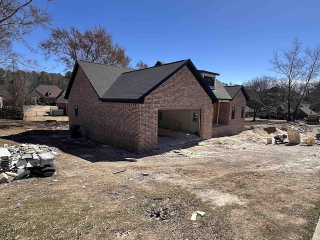 view of property exterior featuring a garage and brick siding