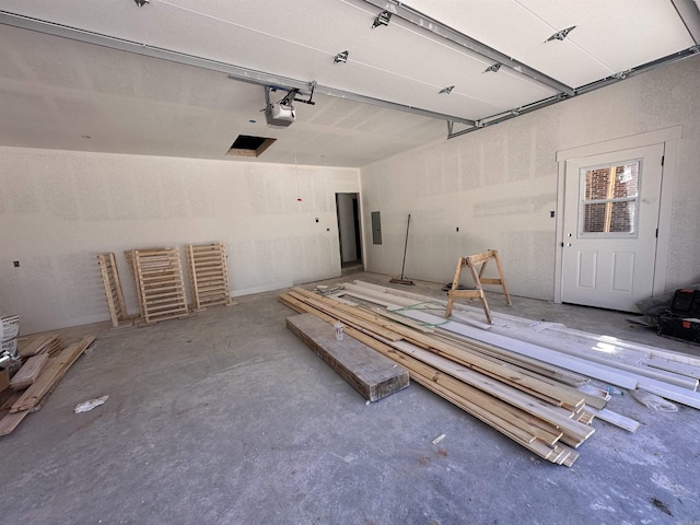 garage featuring electric panel and a garage door opener