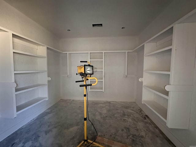 interior space featuring visible vents and unfinished concrete flooring