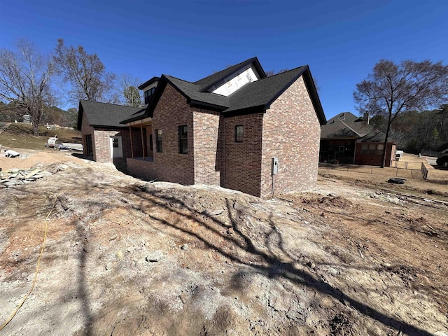 view of home's exterior with brick siding