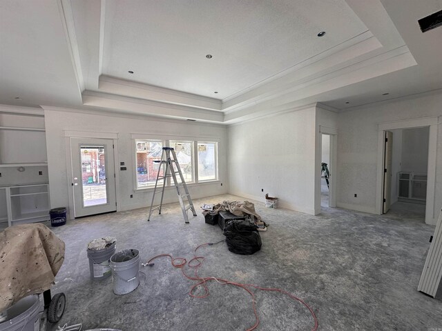 unfurnished living room with visible vents, a raised ceiling, and ornamental molding