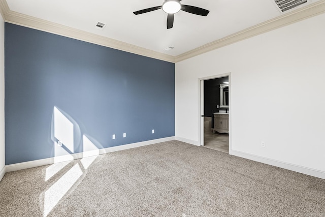 spare room featuring baseboards, visible vents, and ornamental molding