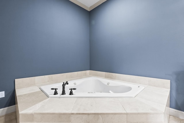 bathroom with baseboards, a whirlpool tub, and crown molding