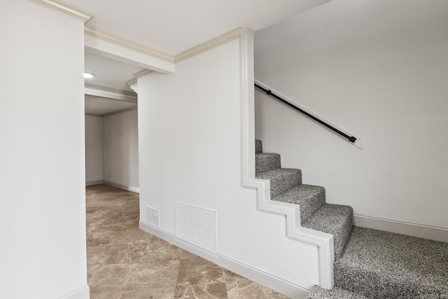 stairs featuring visible vents, baseboards, and ornamental molding