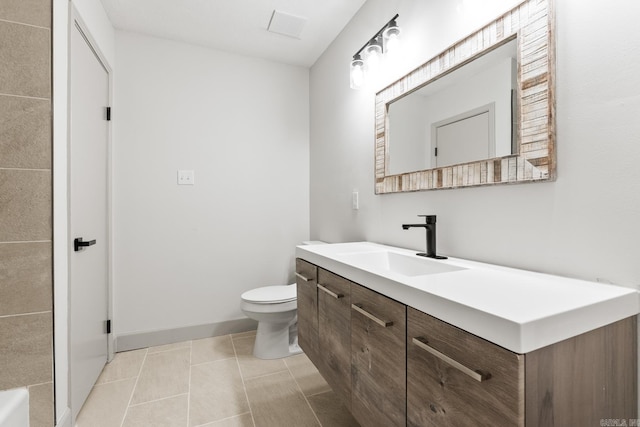 bathroom with tile patterned flooring, toilet, vanity, and baseboards