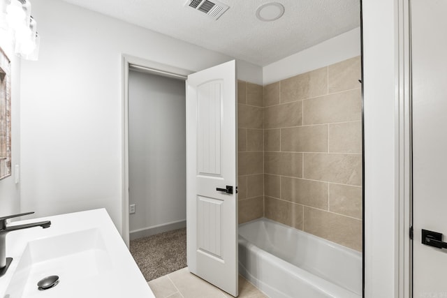 bathroom with tile patterned floors, visible vents, a sink, a textured ceiling, and shower / bath combination