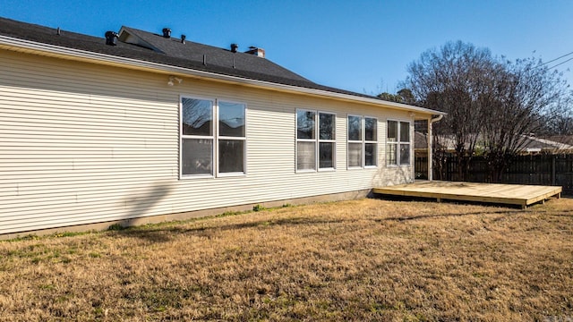 view of side of home with a lawn and a wooden deck