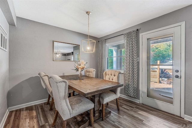 dining area featuring wood finished floors and baseboards