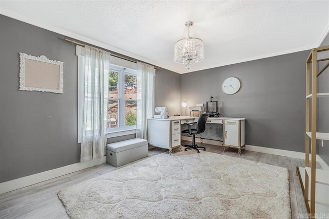 office area with ornamental molding, a textured ceiling, and wood finished floors