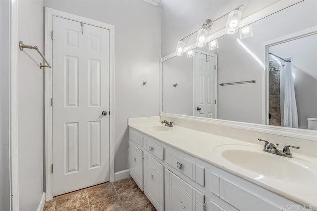 bathroom featuring double vanity, a shower with curtain, and a sink