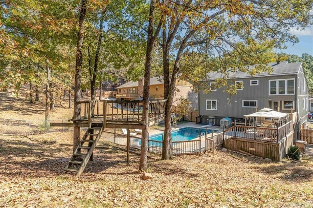 view of pool with a wooden deck, a fenced in pool, and fence