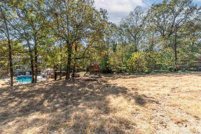 view of yard with a fenced in pool and fence