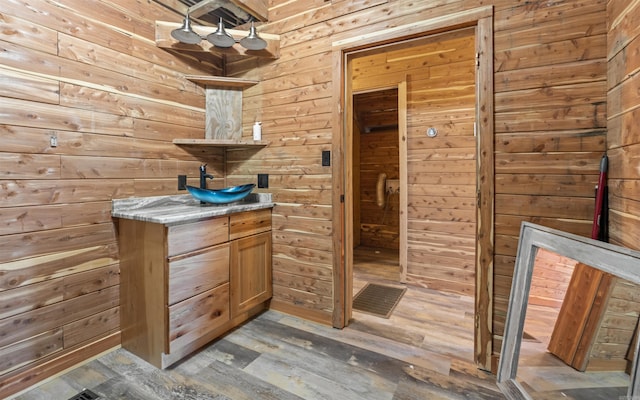 bathroom featuring wood walls and wood finished floors