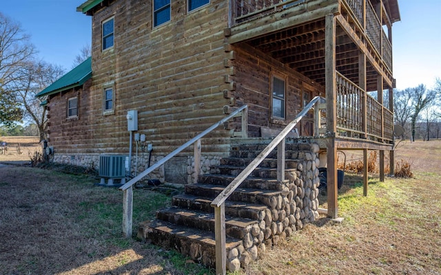 view of side of property with log siding, crawl space, metal roof, and central AC