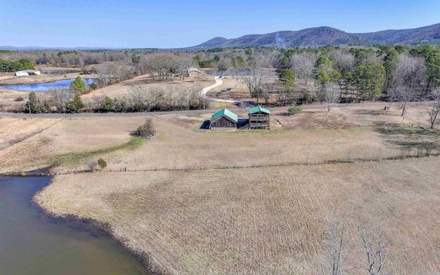 drone / aerial view featuring a water and mountain view and a rural view