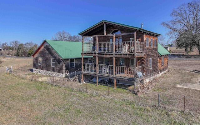 rear view of property featuring metal roof