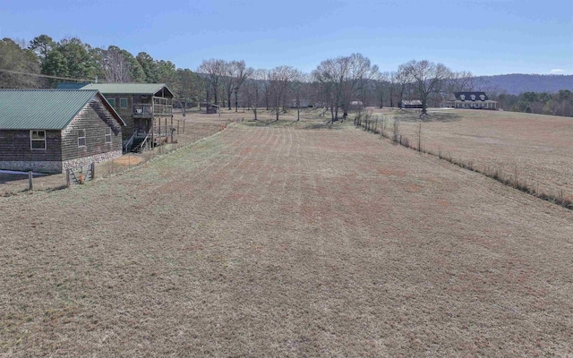 view of yard featuring a rural view and fence