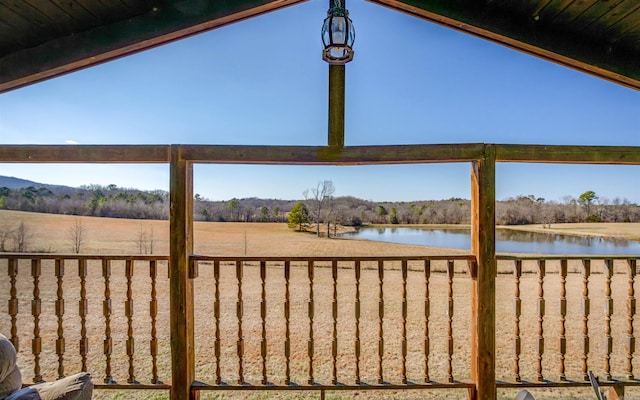 exterior space featuring a water view and fence