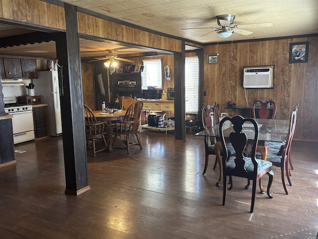 dining area featuring dark wood finished floors, an AC wall unit, and a ceiling fan