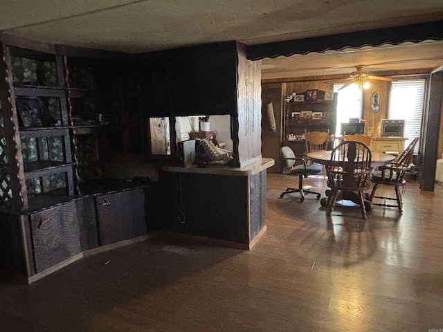 dining space with a ceiling fan and wood finished floors