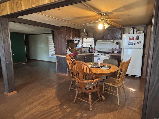 dining room featuring a ceiling fan, dark wood-style floors, and baseboards