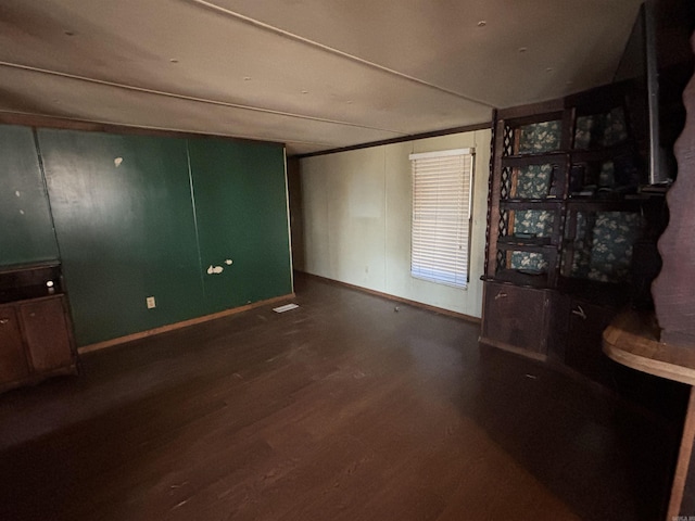 living area with wood finished floors and baseboards