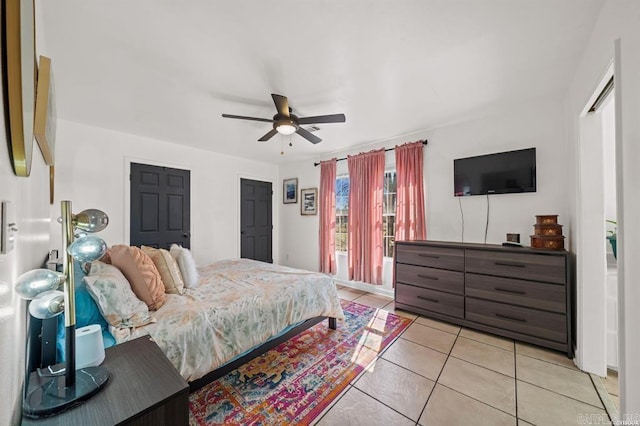 bedroom with light tile patterned floors and ceiling fan