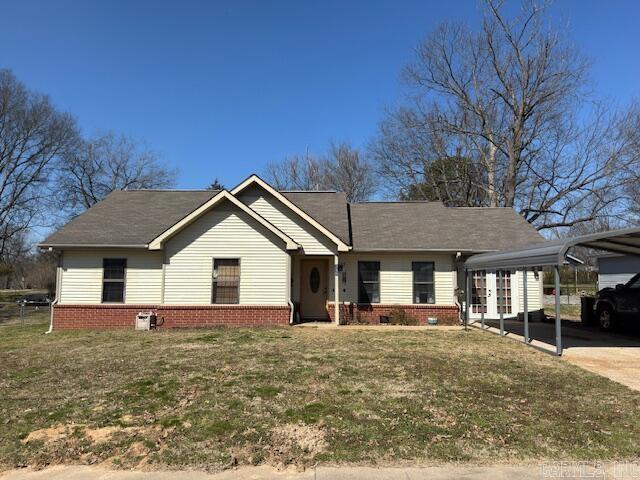 ranch-style home with a detached carport, crawl space, concrete driveway, and a front yard