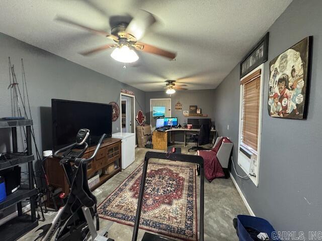 office with baseboards, a textured ceiling, and a ceiling fan