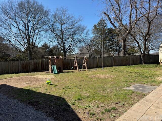 view of yard with a playground and a fenced backyard