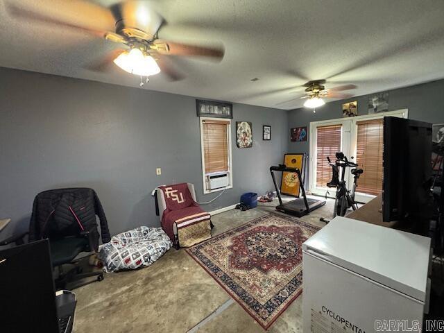 interior space with concrete floors, cooling unit, a textured ceiling, fridge, and a ceiling fan